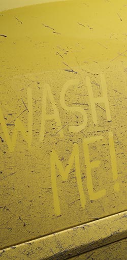 wash me written on car door